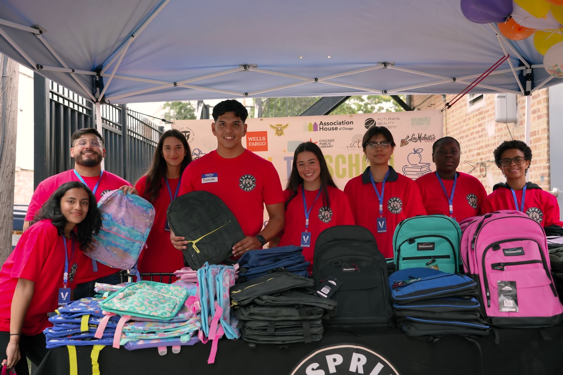 Volunteers and neighbors packing 344 backpacks at the Esprit de Corps Foundation Back to School Community Day in Back of the Yards, Chicago